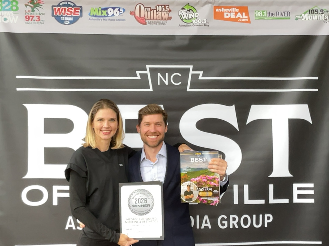 Dr. Sarah Long and Eric Rodriguez accepting the 2026 Best of Asheville Silver Award for Cosmetic Surgery